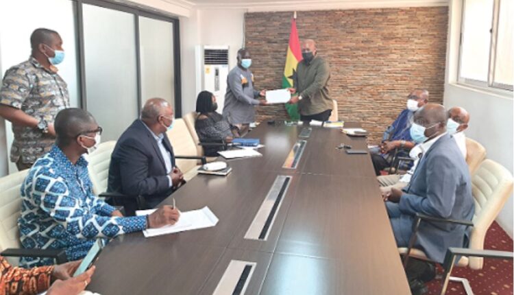 Prof. Samuel Kobina Annim (arrowed), presenting copies of the census resources to former President John Dramani Mahama