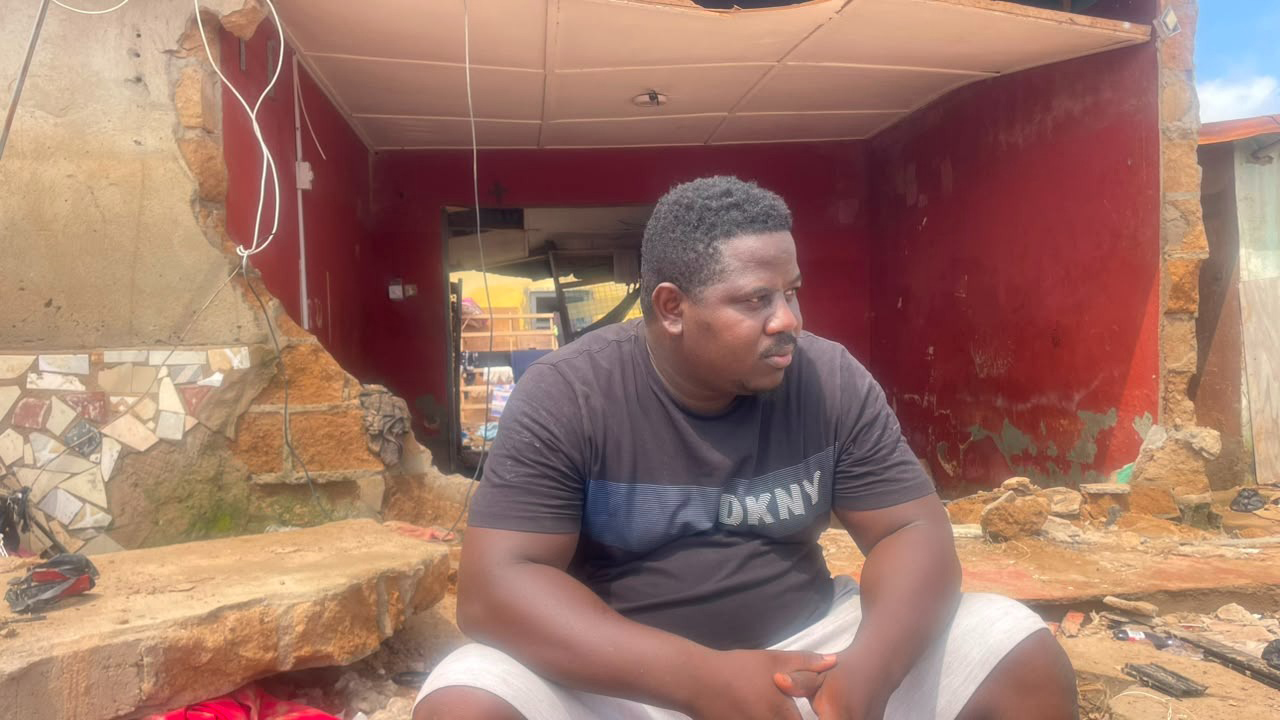 Ibrahim Mubarak, sitting on the debris of his partially collapsed room