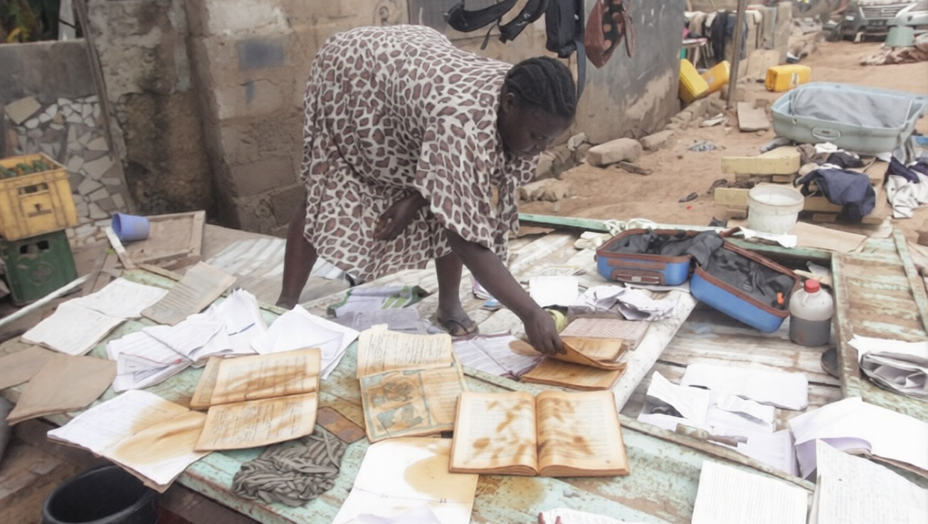 Georgina Adjowoda, gently turning the soaked books